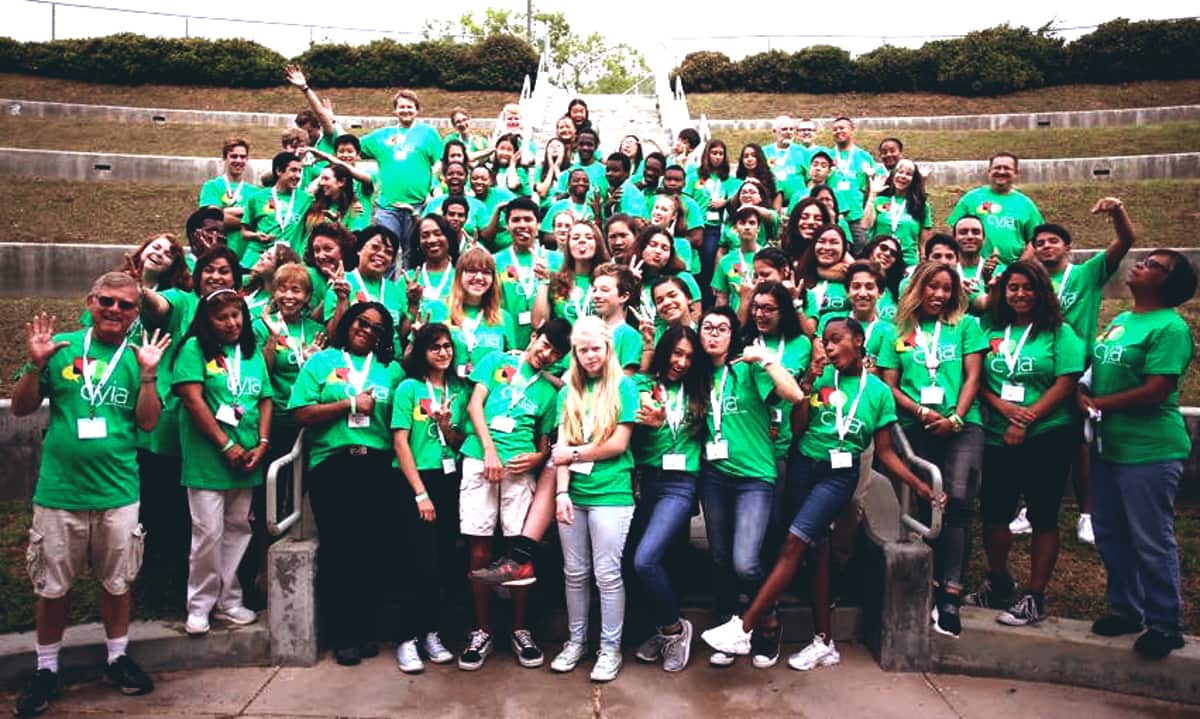 A large group of CYIA students in green shirts at summer training camp
